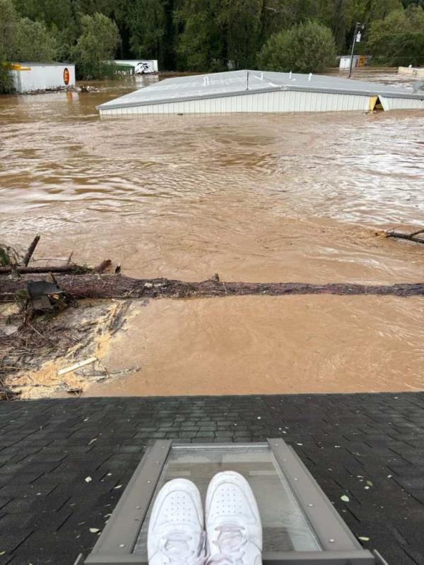 Jessica Drye Turner posted a photo taken by her sister, Megan Drye -- who, along with their “parents, in their 70s,” and her nephew, Micah, 7, were trapped on top of their Asheville home.
