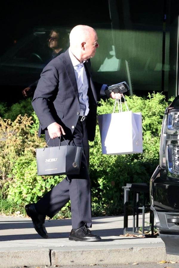 Washington , DC, October 10th 2024.
United States Secretary of Homeland Security, Alejandro Mayorkas pics up two bags of take away food from high end restaurant Nobu.